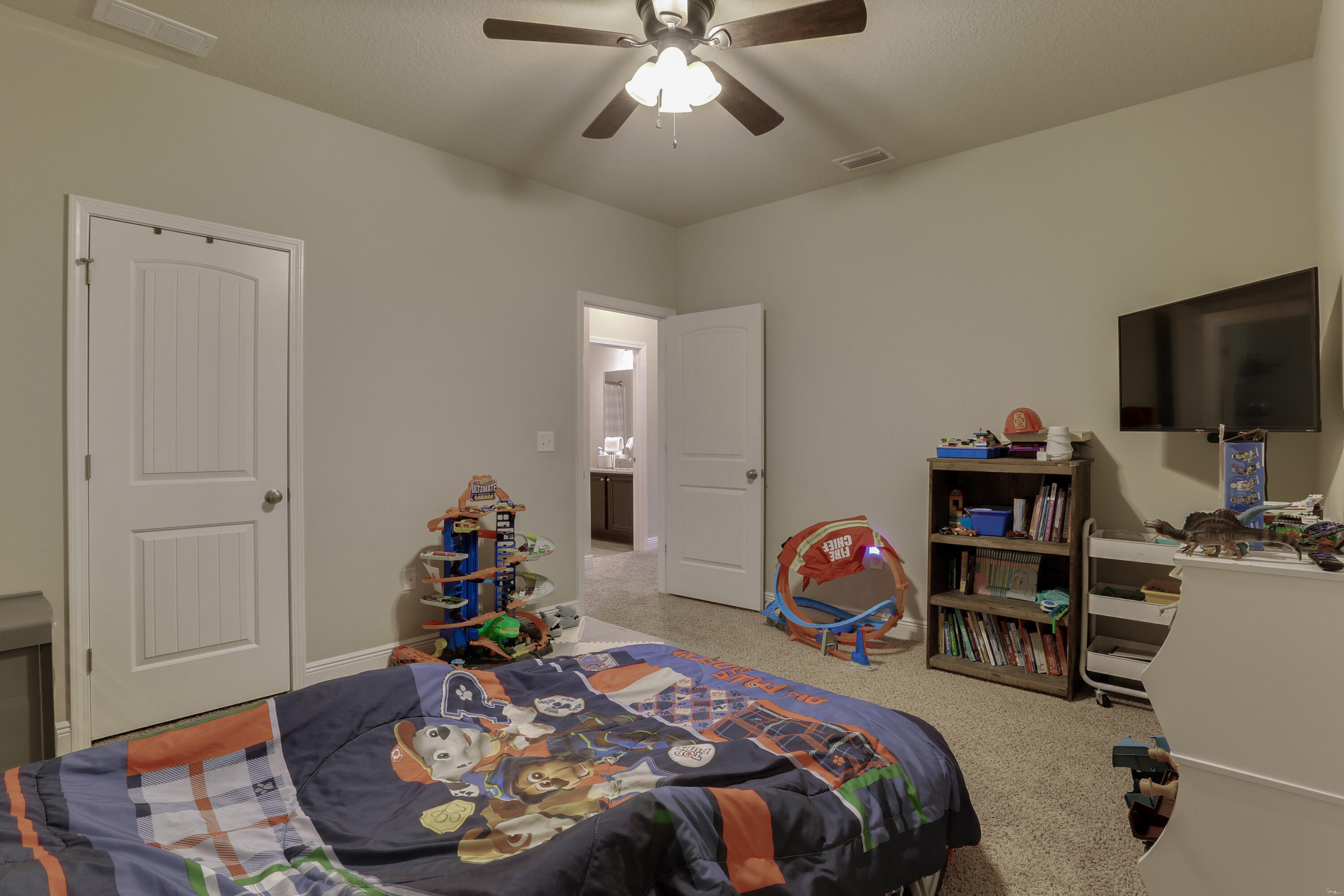 671 Teal Street Crestview, FL 32539 - Photo 24 of 41 a bedroom with bed and a chandelier