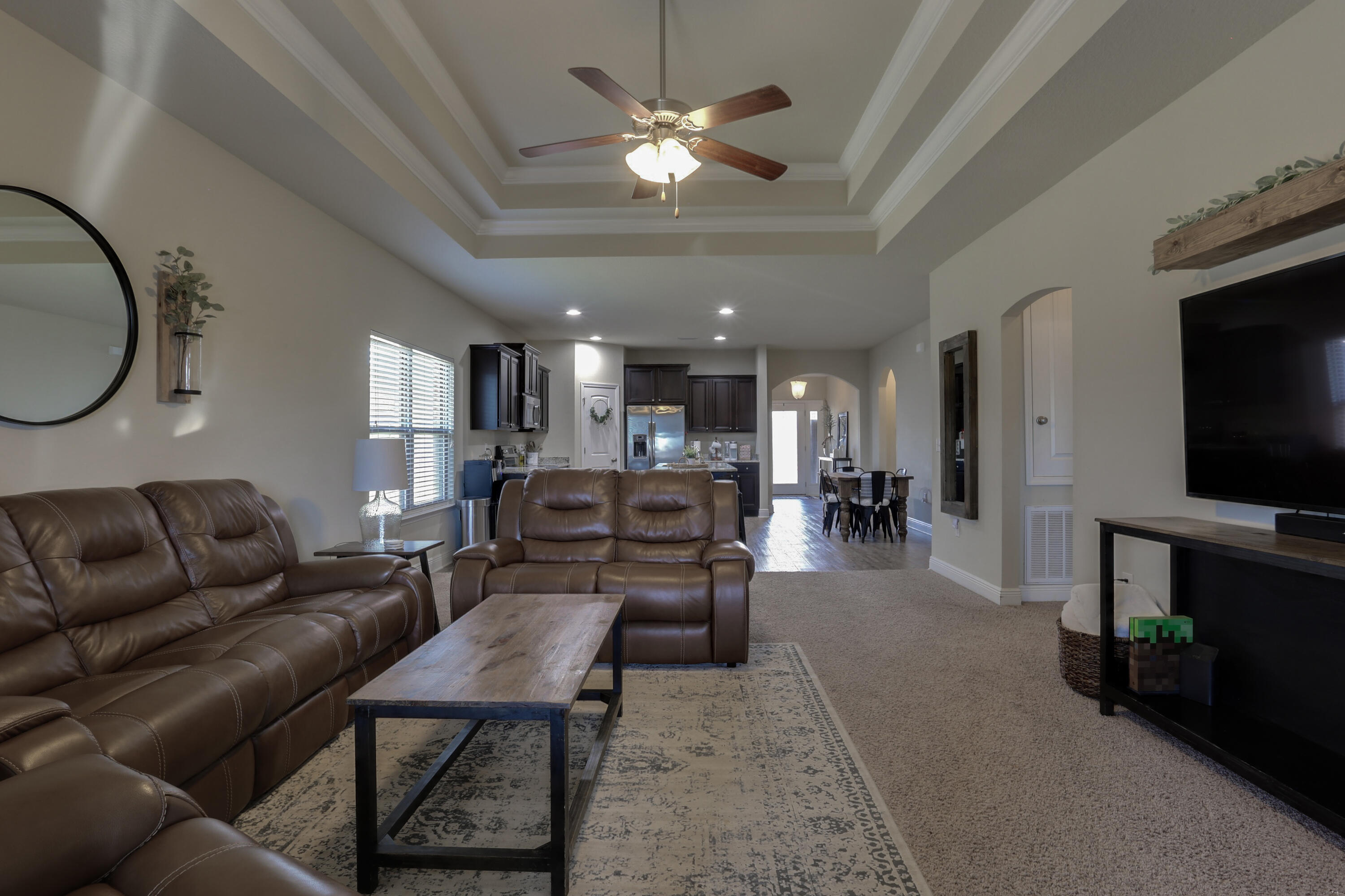 671 Teal Street Crestview, FL 32539 - Photo 26 of 41 a living room with furniture a flat screen tv and kitchen view