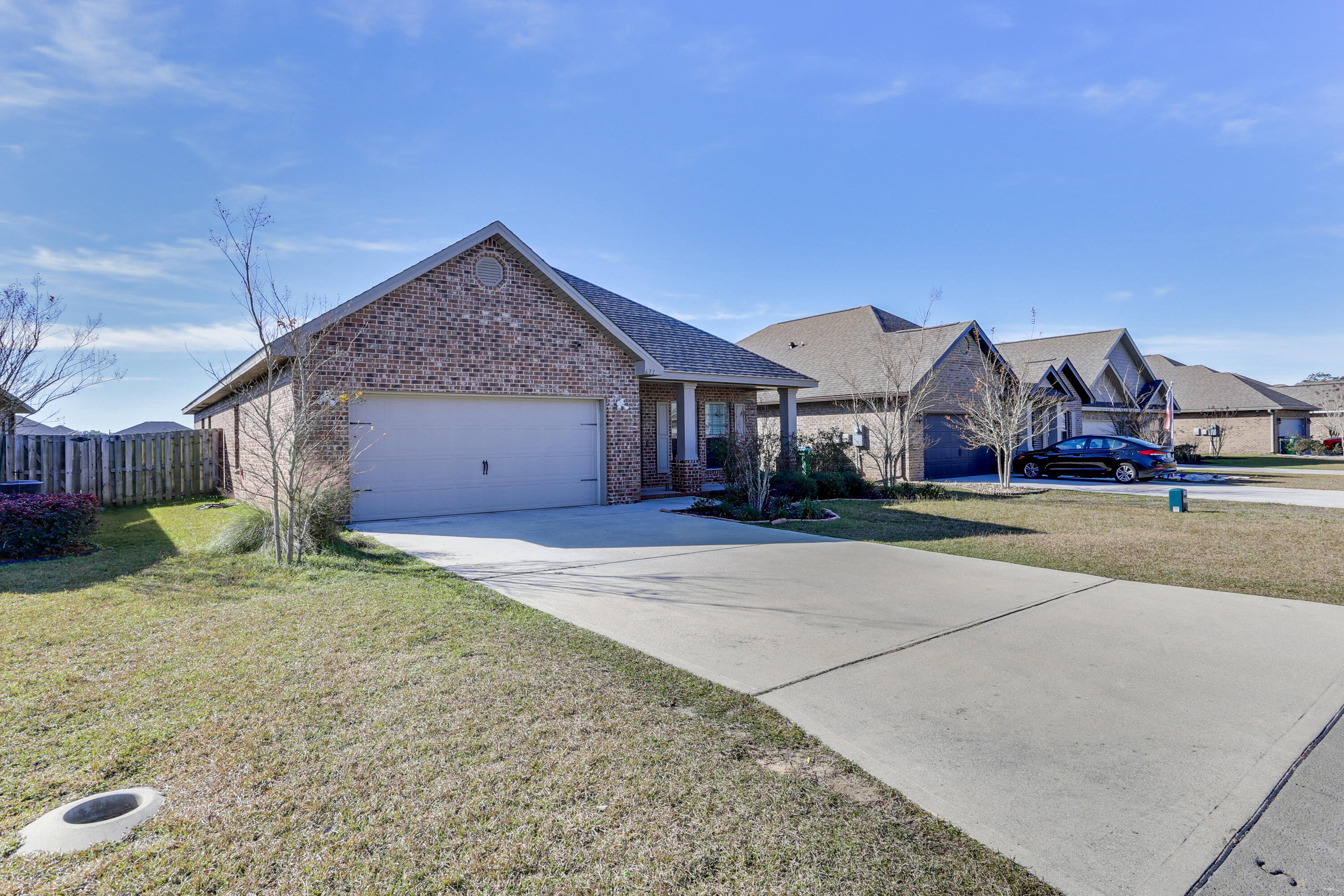 671 Teal Street Crestview, FL 32539 - Photo 3 of 41 a front view of a house with a yard and garage