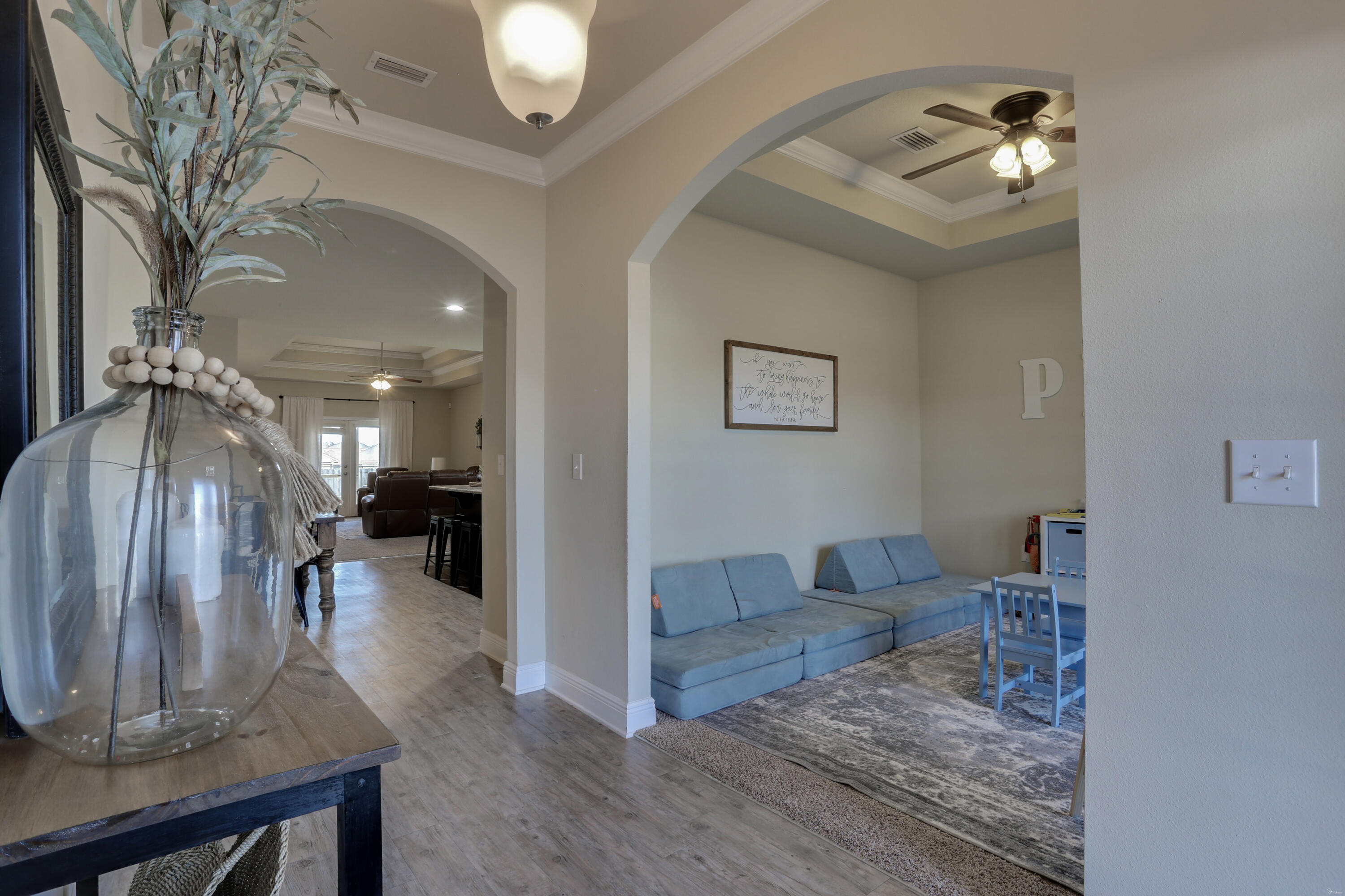 671 Teal Street Crestview, FL 32539 - Photo 8 of 41 a living room with furniture and a chandelier