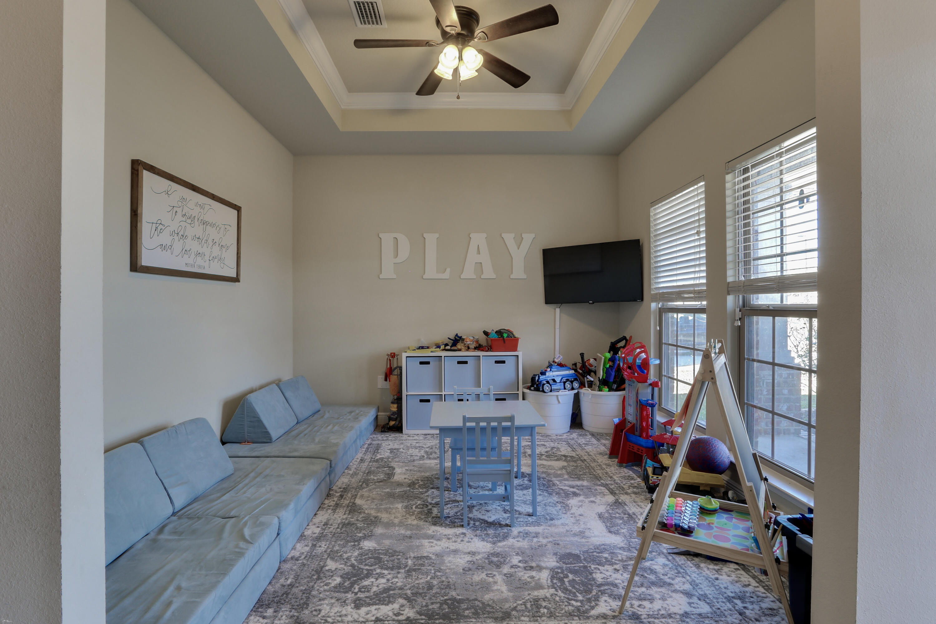 671 Teal Street Crestview, FL 32539 - Photo 9 of 41 a living room with furniture and a flat screen tv