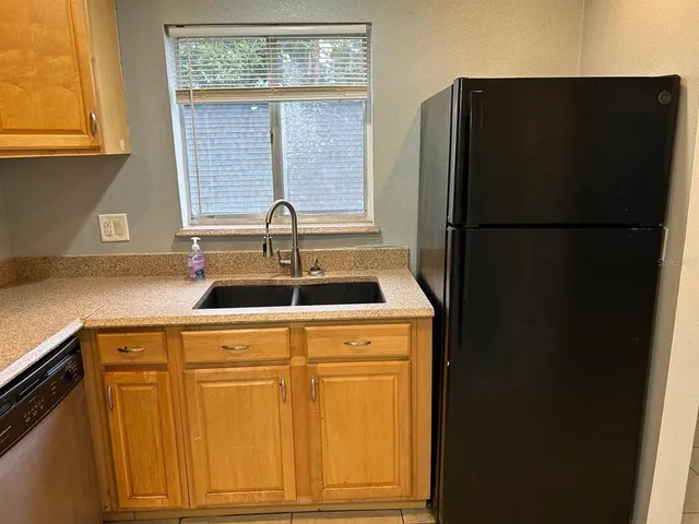 a kitchen with a refrigerator and a sink
