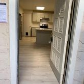 a kitchen with cabinets and a refrigerator