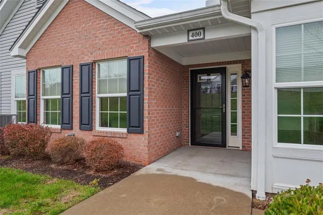 a view of a brick house with a large window