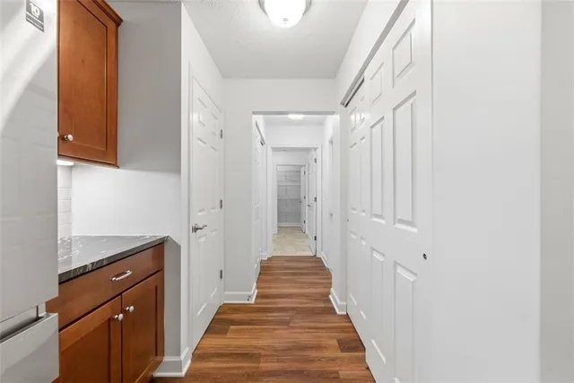 wooden floor in an empty room with a bathroom