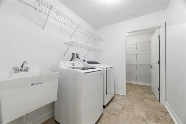 a utility room with cabinets washer and dryer