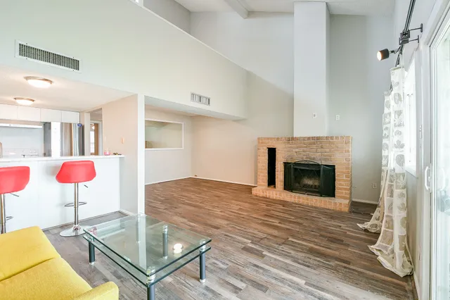 a view of a livingroom with a fireplace and cabinet