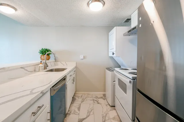 a kitchen with a sink and a stove top oven