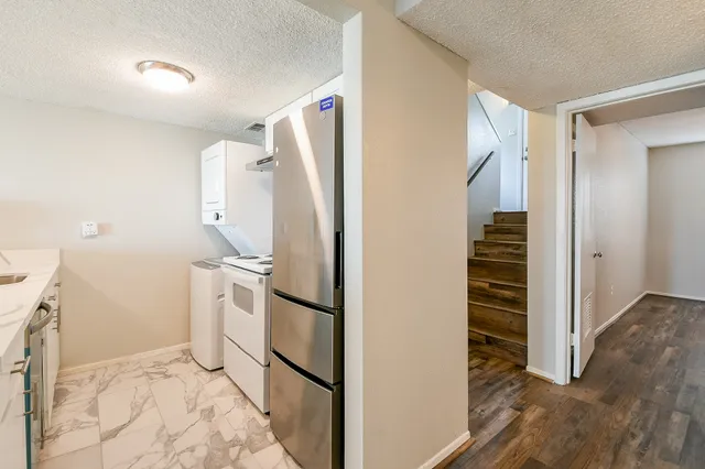 a view of a kitchen with wooden floor and electronic appliances