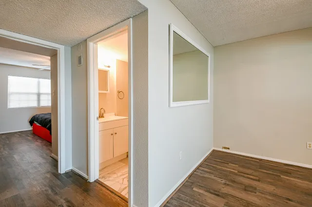 a view of an empty room and wooden floor