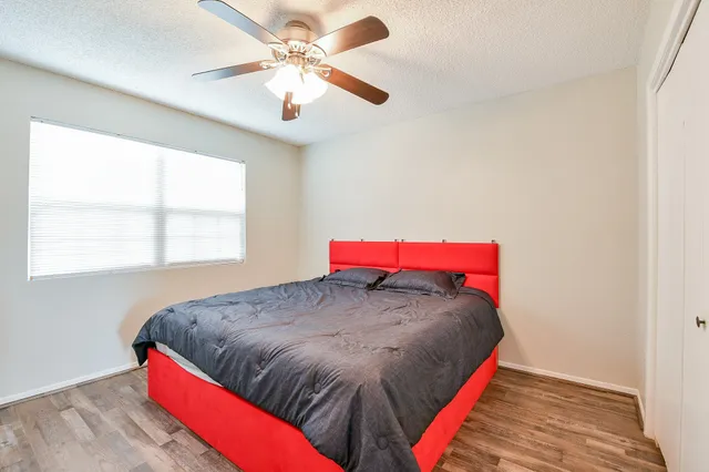 a bed sitting in a bedroom next to a window