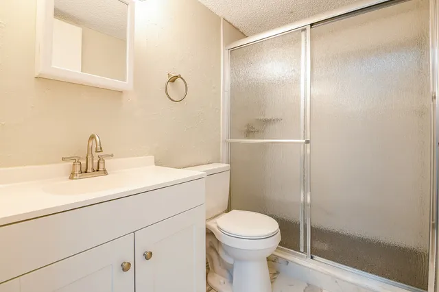 a bathroom with a sink a mirror and a shower