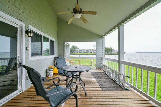 a view of a balcony with furniture and wooden floor
