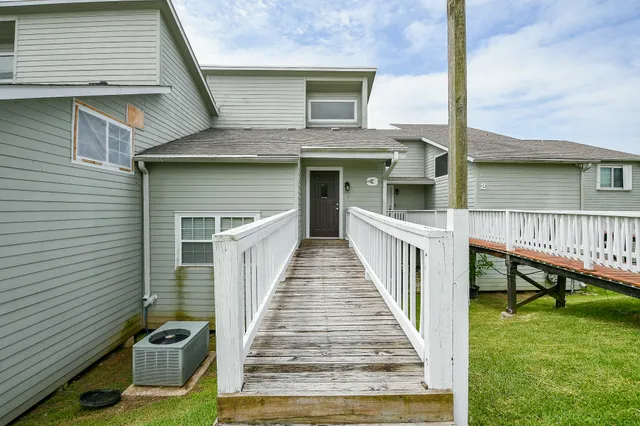 a view of a house with wooden deck