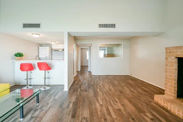 a view of an empty room and wooden floor