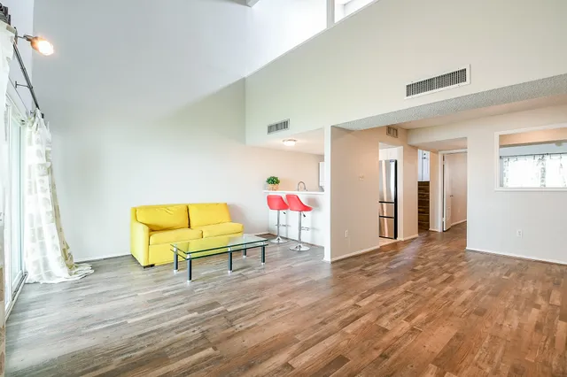 a room with a wooden floor and a chandelier