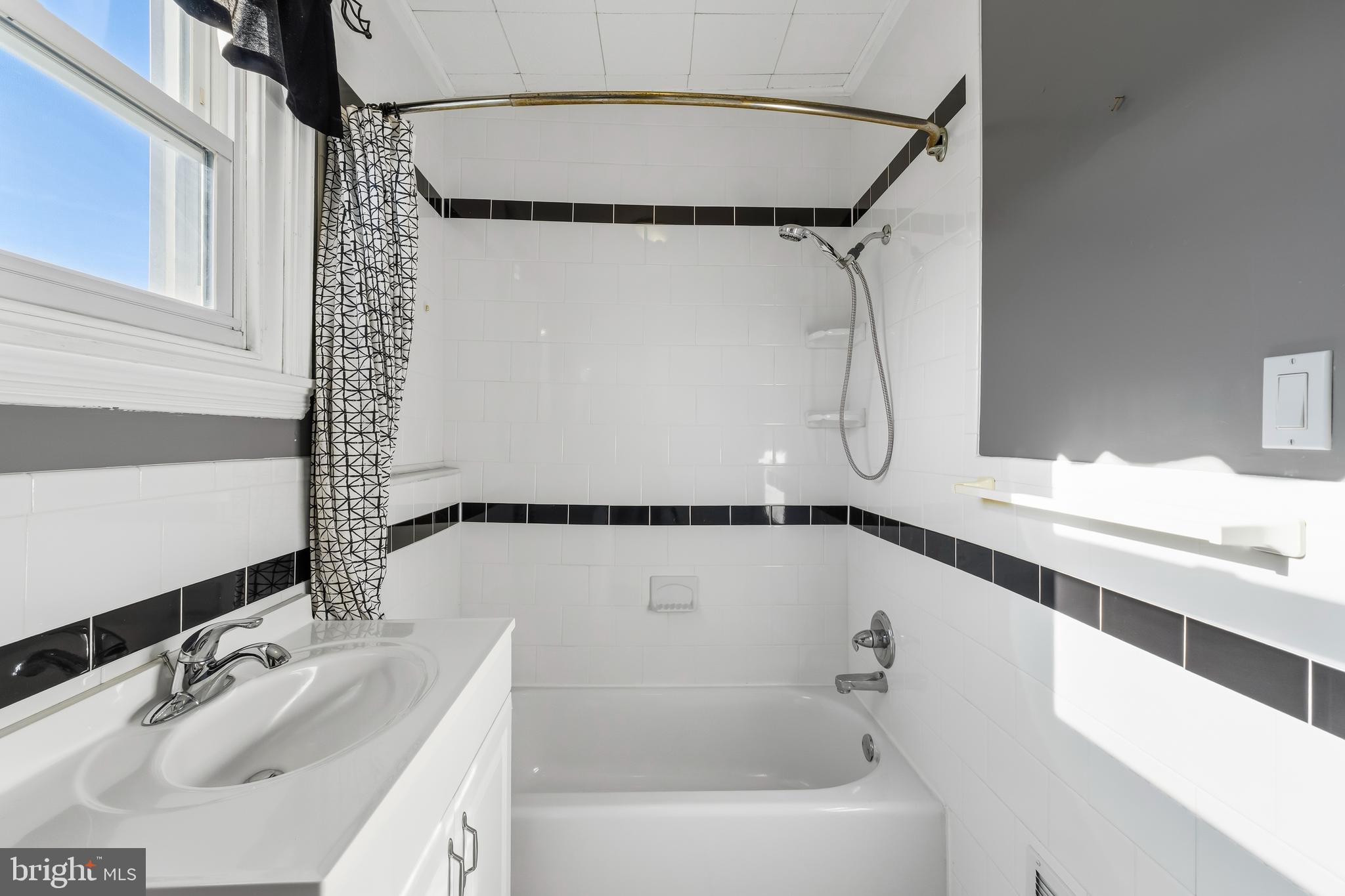 3061 Livingston Street Philadelphia, PA 19134 - Photo 15 of 28 a bathroom with a tub sink and mirror