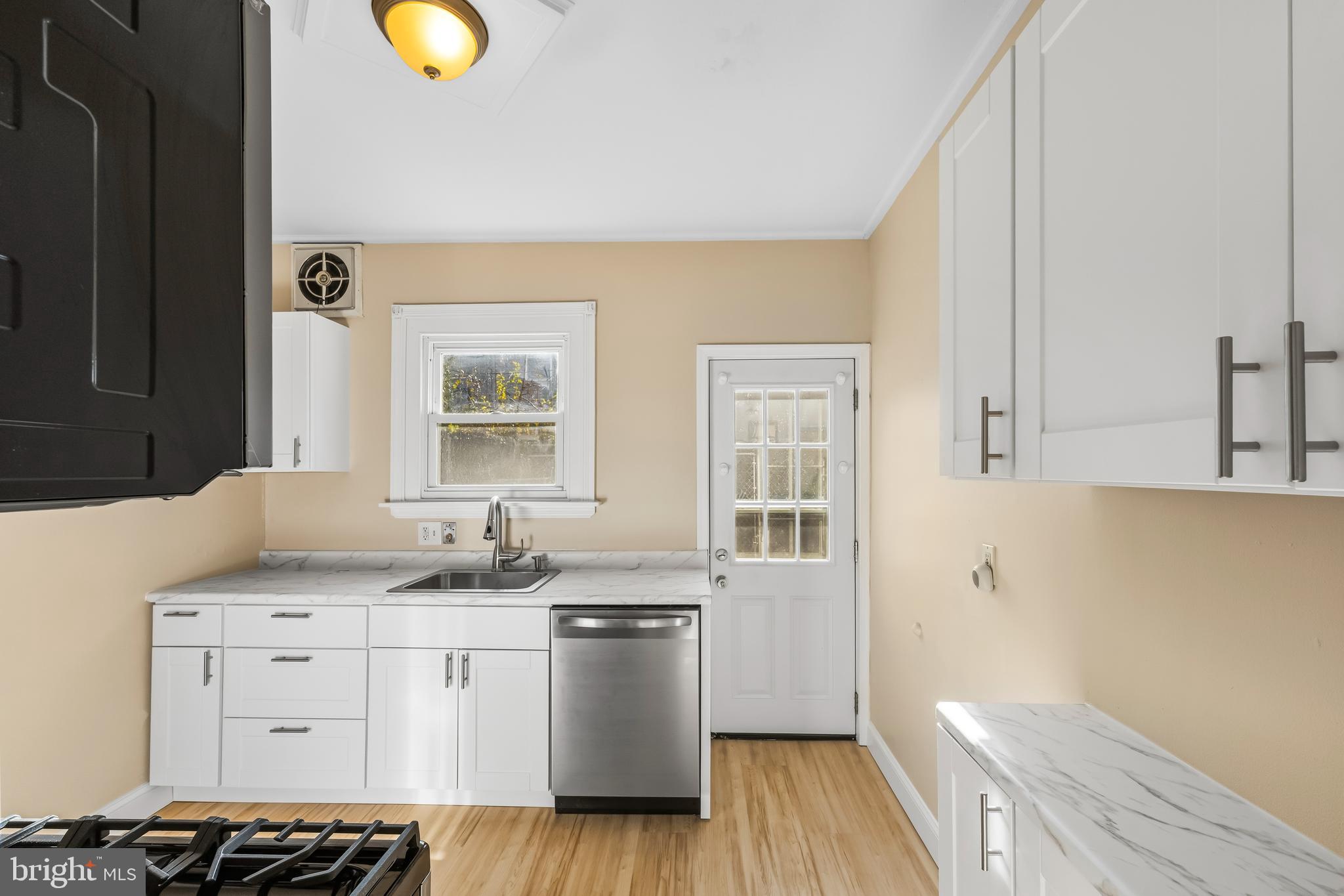 3061 Livingston Street Philadelphia, PA 19134 - Photo 7 of 28 a bathroom with a granite countertop sink and a mirror