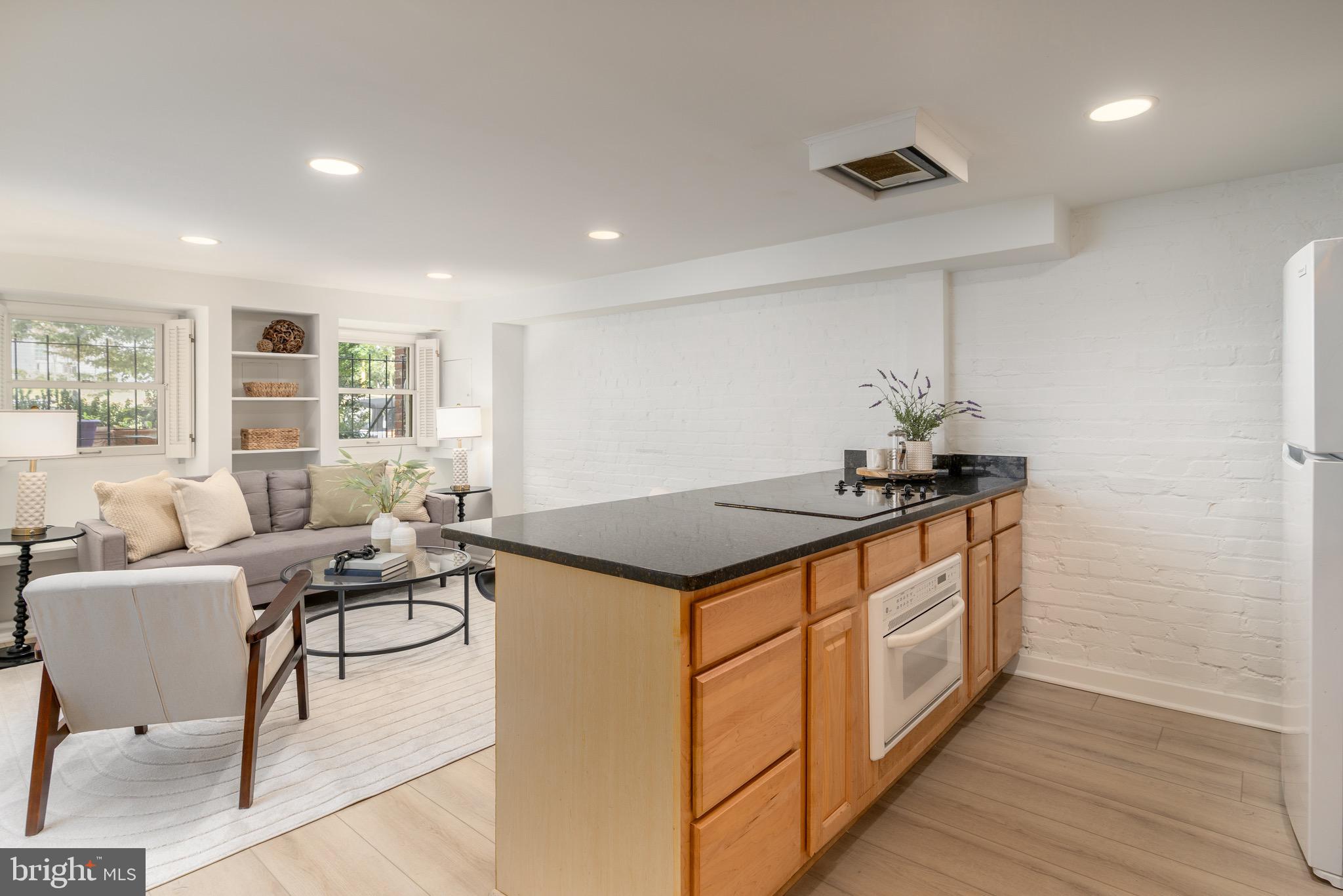 1683 35th Street Northwest, Unit B Washington, DC 20007 - Photo 5 of 10 a living room with stainless steel appliances granite countertop furniture and a wooden floor