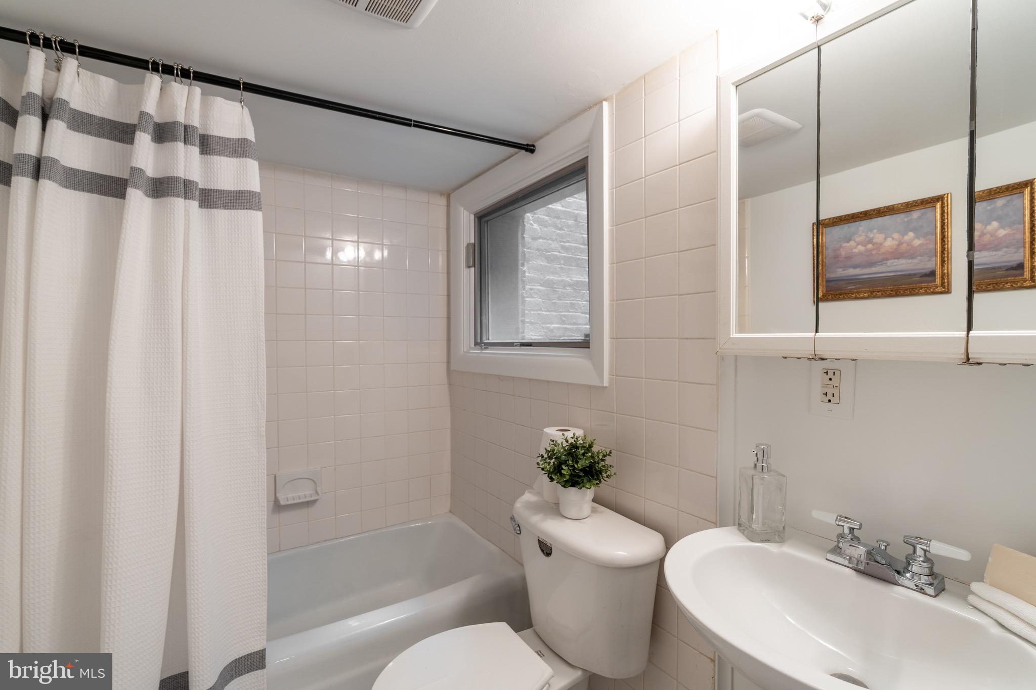 1683 35th Street Northwest, Unit B Washington, DC 20007 - Photo 9 of 10 a bathroom with a sink toilet and shower