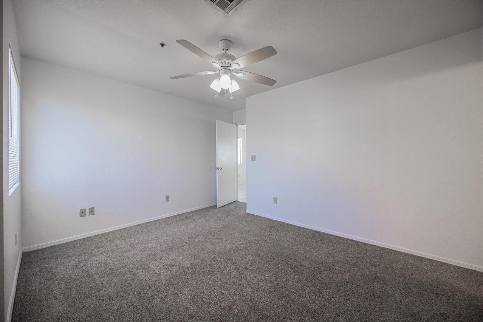 16033 North 25th Street, Unit 202 Phoenix, AZ 85032 - Photo 11 of 18 an empty room with a fan and a fan
