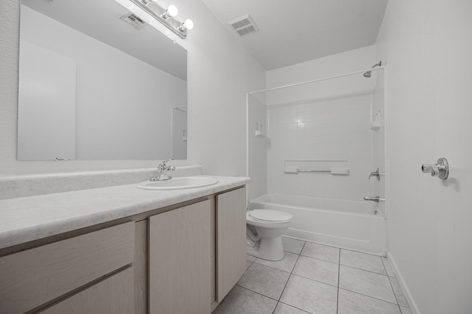 16033 North 25th Street, Unit 202 Phoenix, AZ 85032 - Photo 12 of 18 a bathroom with a sink a toilet and shower