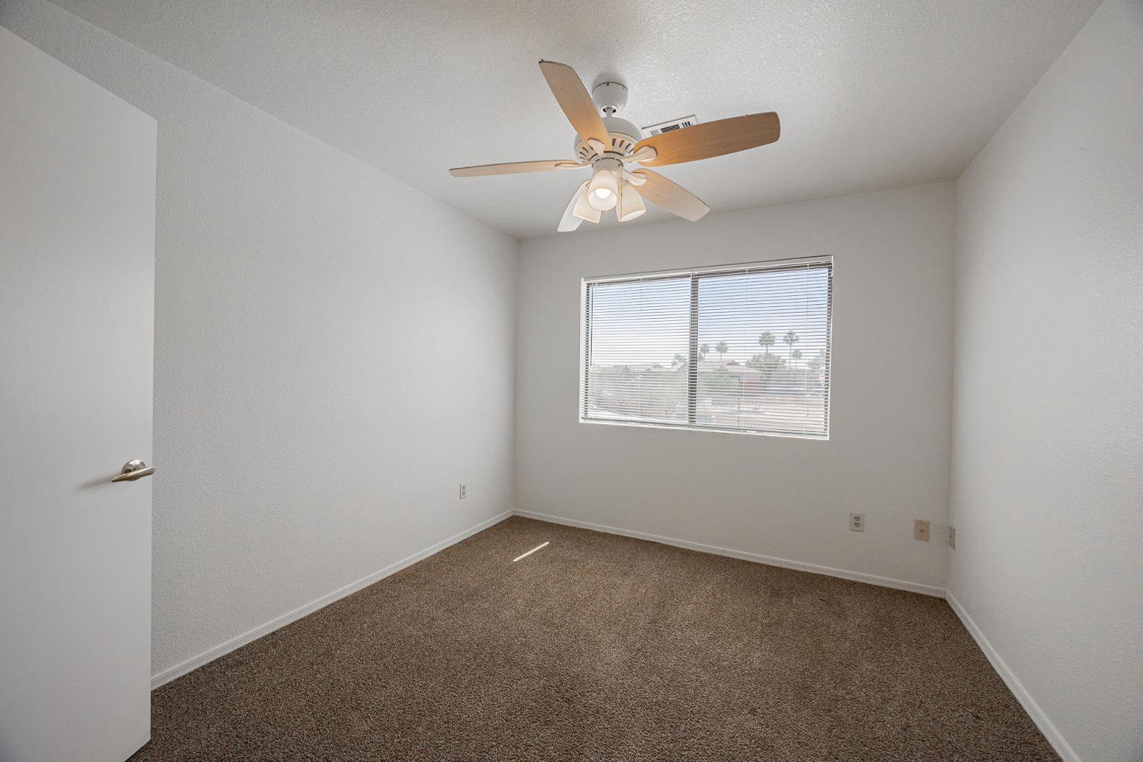 16033 North 25th Street, Unit 202 Phoenix, AZ 85032 - Photo 16 of 18 an empty room with a window and ceiling fan