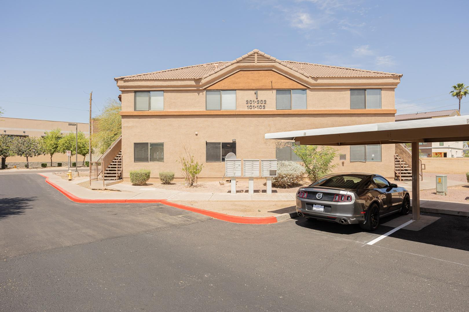 16033 North 25th Street, Unit 202 Phoenix, AZ 85032 - Photo 2 of 18 a view of a car parked in front of a house