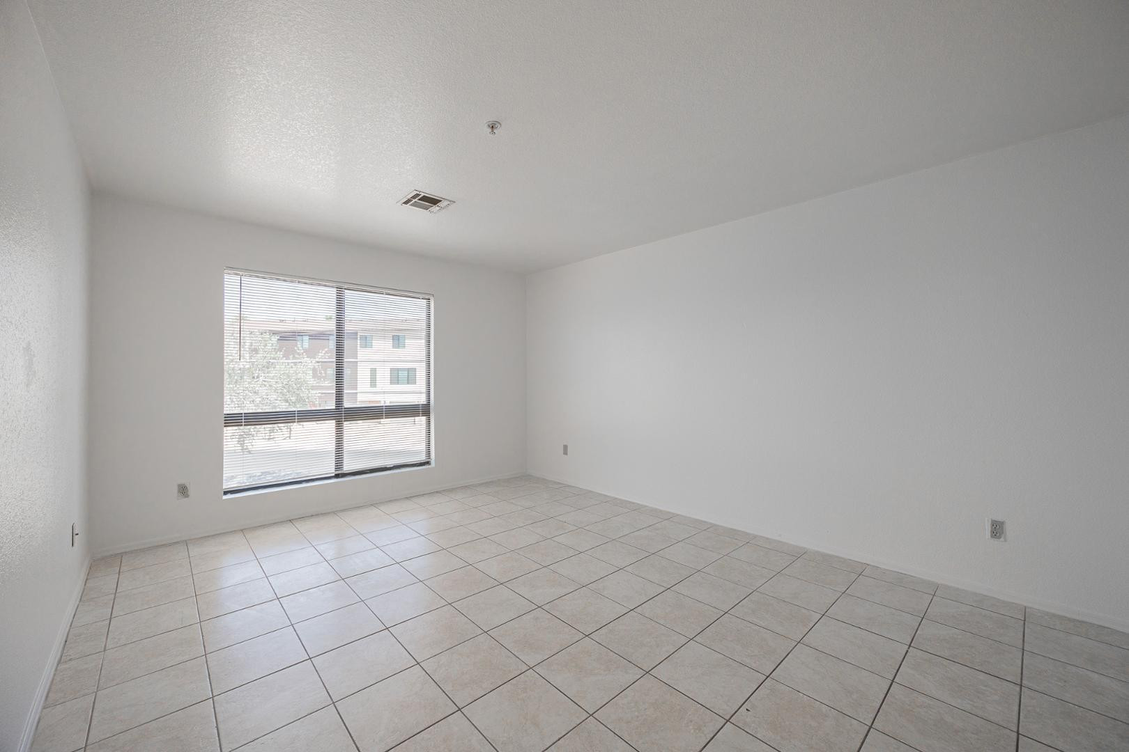 16033 North 25th Street, Unit 202 Phoenix, AZ 85032 - Photo 4 of 18 an empty room with windows