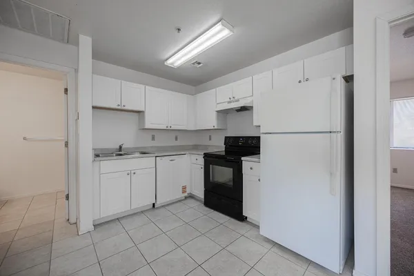 a kitchen with cabinets stainless steel appliances and a counter space
