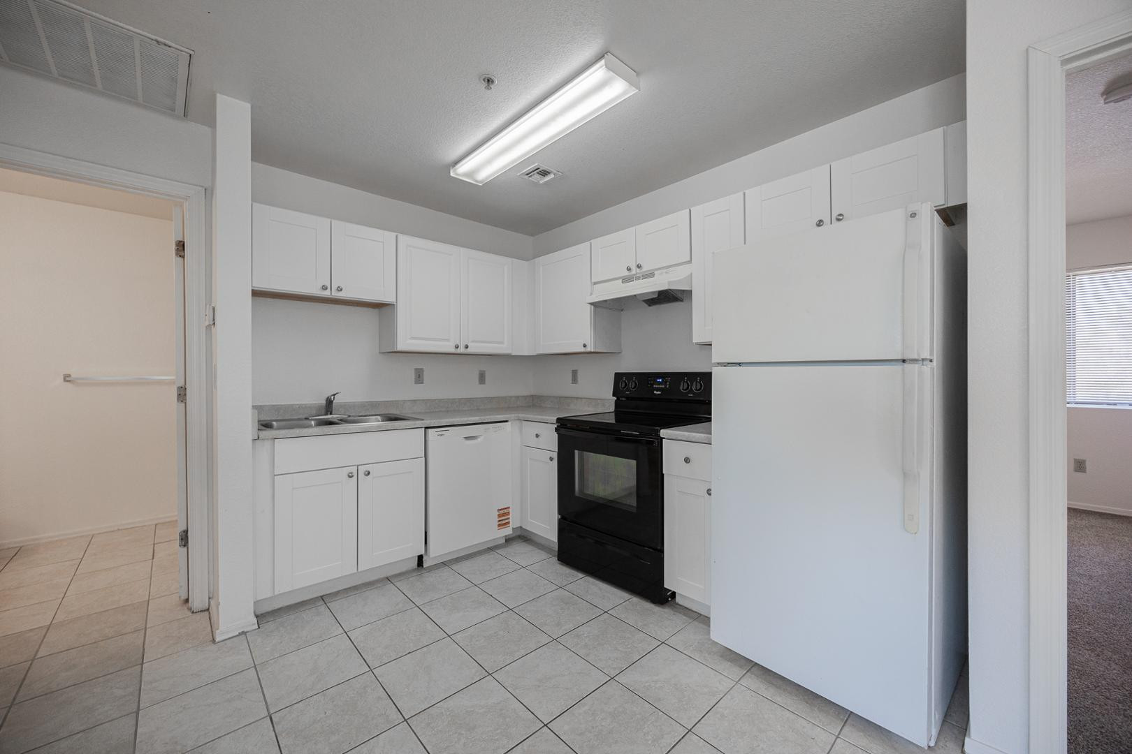 16033 North 25th Street, Unit 202 Phoenix, AZ 85032 - Photo 8 of 18 a kitchen with cabinets stainless steel appliances and a counter space