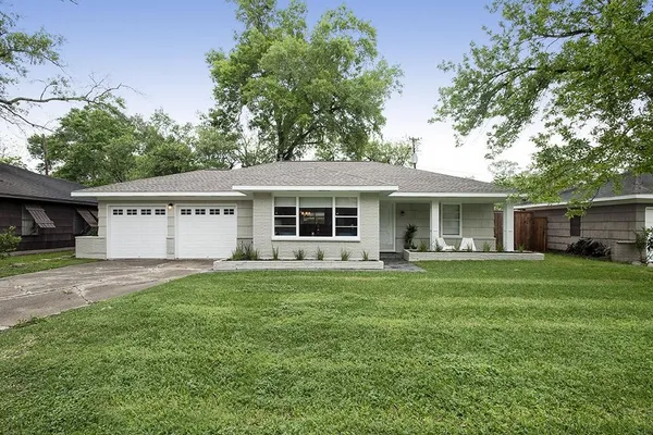 a front view of a house with a garden and porch