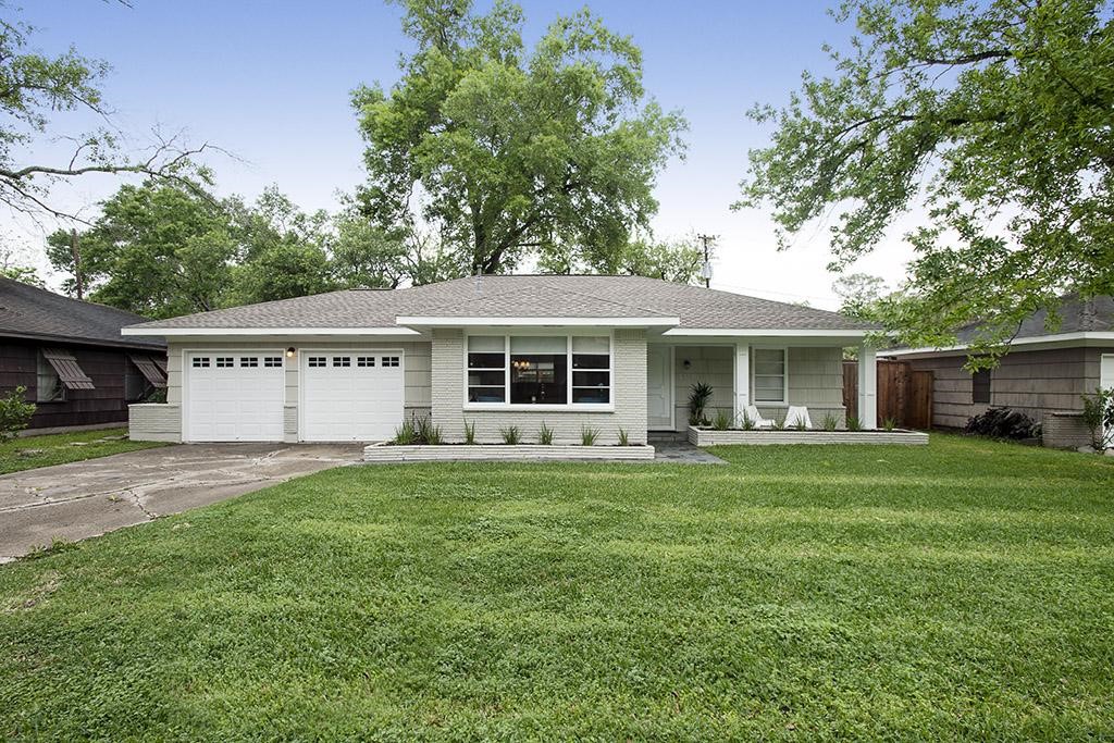 a front view of a house with a garden and porch