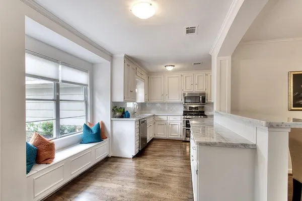 a kitchen with refrigerator and window