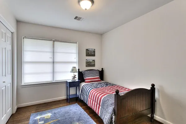 a bedroom with a bed and window