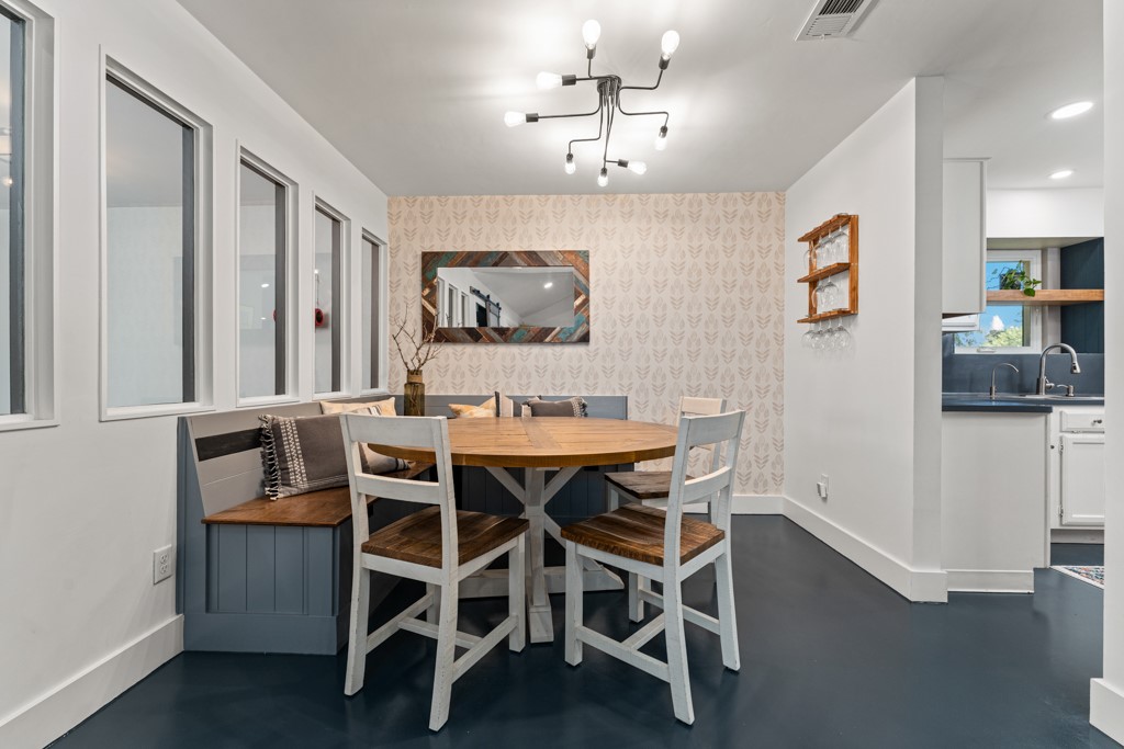 1502 Quail Run Road Pflugerville, TX 78660 - Photo 9 of 37 An inviting dining area offers built-in bench seating and a contemporary overhead light fixture.