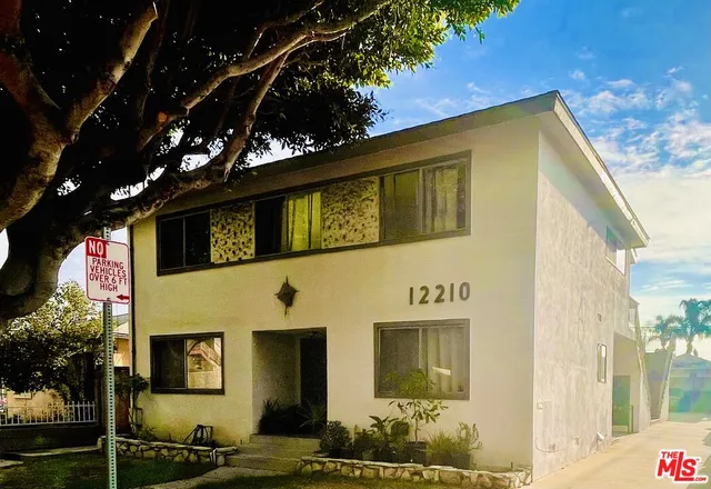 a front view of a house with trees