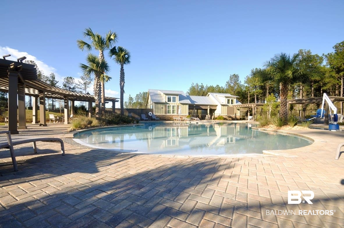 32125 Lyon Road Daphne, AL 36527 - Photo 57 of 70 Freeform swimming pool surrounded by a paver patio