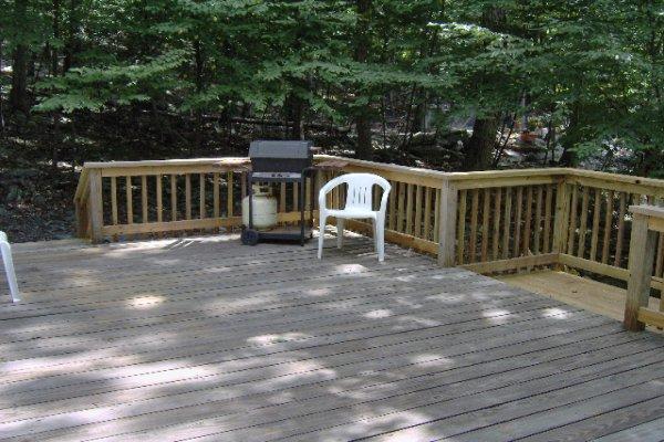 630 Decker Road Bushkill, PA 18324 - Photo 4 of 7 a view of a wooden deck and a yard with floor to ceiling window