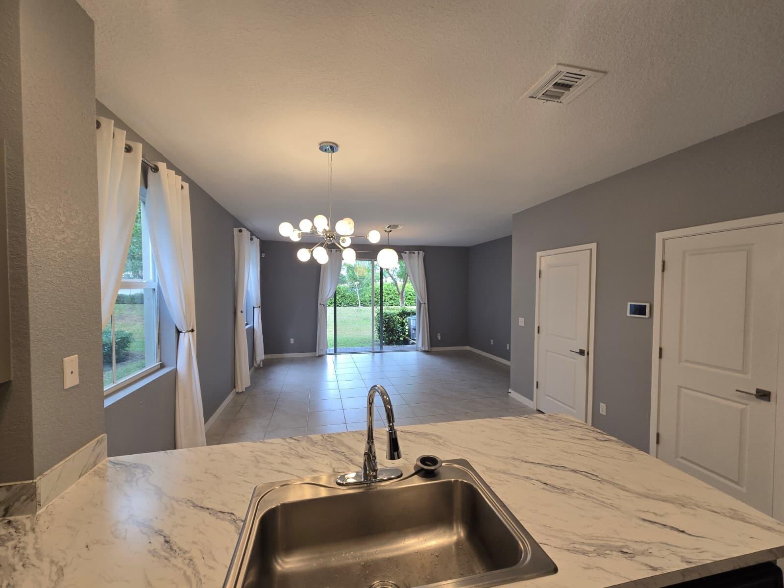 140 Bandol Street Riviera Beach, FL 33404 - Photo 12 of 42 a view of a kitchen from a hallway