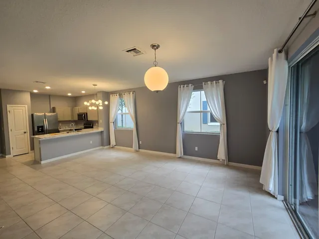 a view of a field with large trees