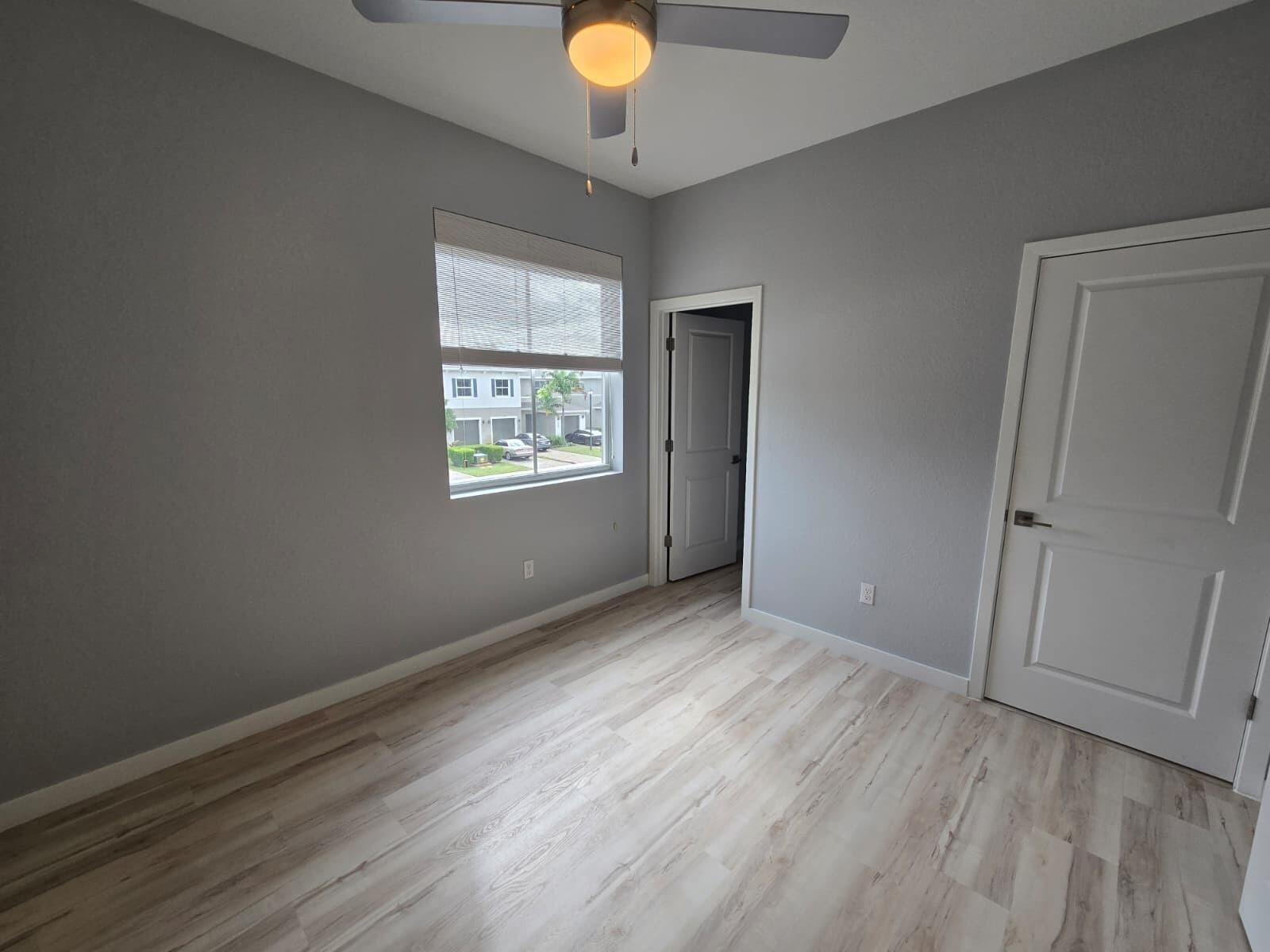 140 Bandol Street Riviera Beach, FL 33404 - Photo 23 of 42 an empty room with wooden floor and windows