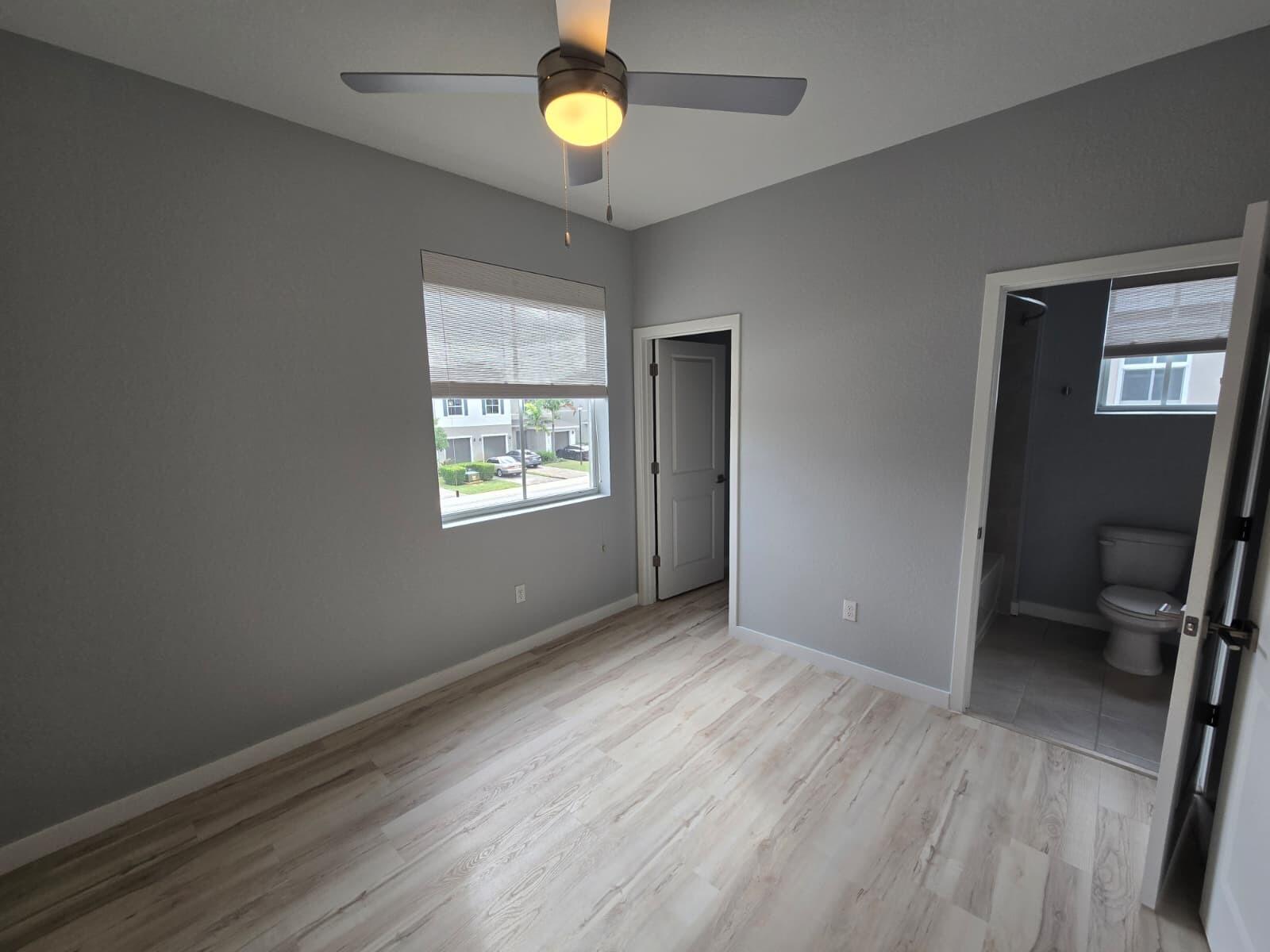 140 Bandol Street Riviera Beach, FL 33404 - Photo 24 of 42 wooden floor in an empty room with a window