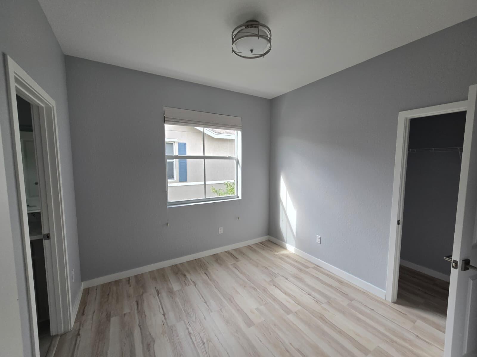 140 Bandol Street Riviera Beach, FL 33404 - Photo 28 of 42 an empty room with wooden floor and windows