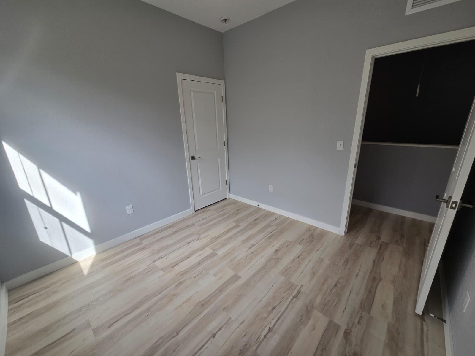 140 Bandol Street Riviera Beach, FL 33404 - Photo 31 of 42 a view of an empty room with wooden floor and a window