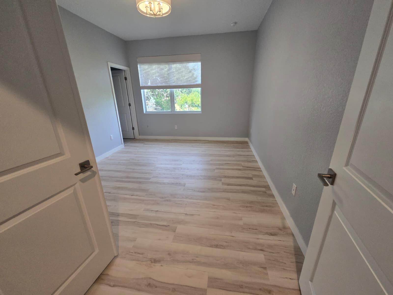 140 Bandol Street Riviera Beach, FL 33404 - Photo 32 of 42 wooden floor in an empty room with a window