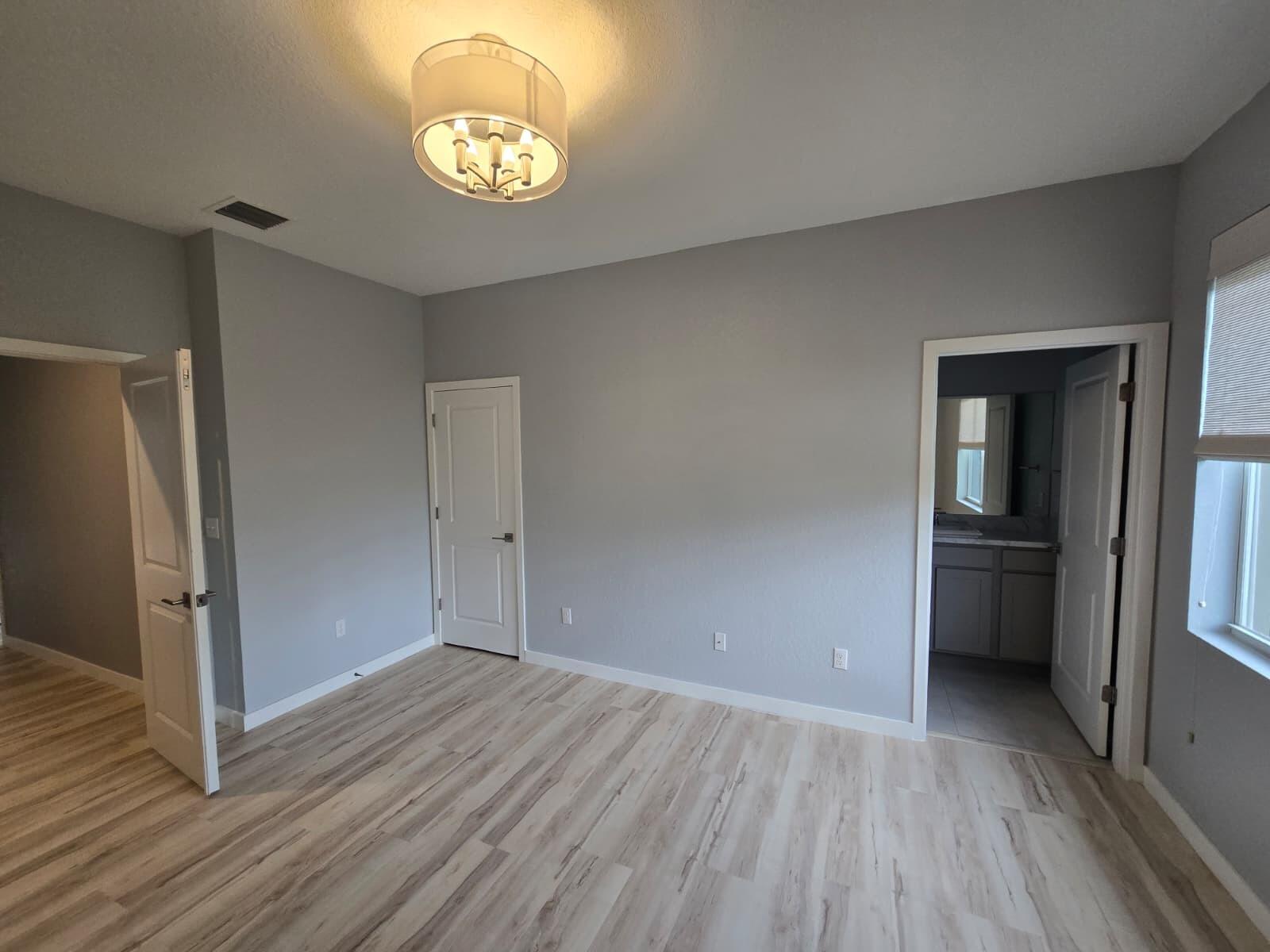 140 Bandol Street Riviera Beach, FL 33404 - Photo 39 of 42 an empty room with wooden floor cabinet and windows