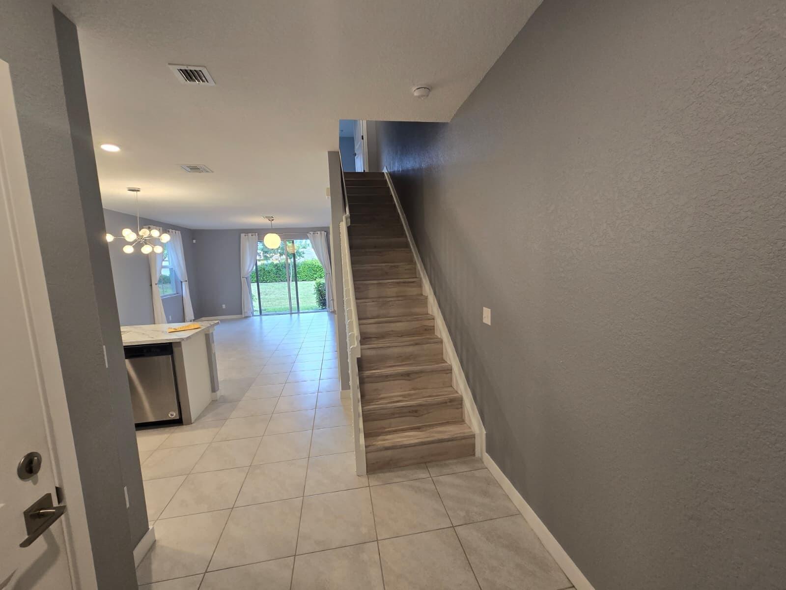 140 Bandol Street Riviera Beach, FL 33404 - Photo 5 of 42 a view of entryway and hall with wooden floor