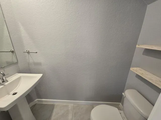 a room with a refrigerator and wooden floor