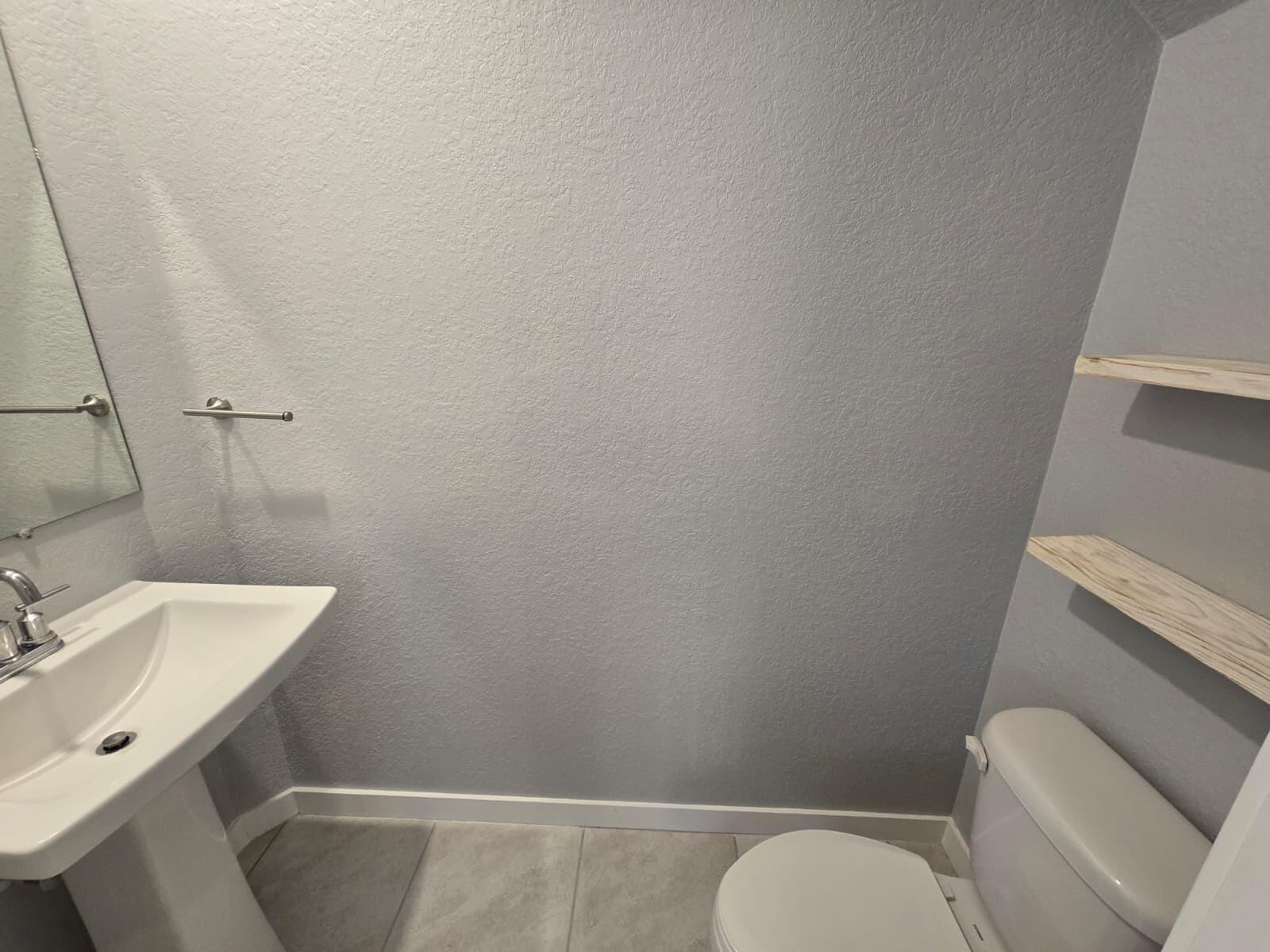 140 Bandol Street Riviera Beach, FL 33404 - Photo 8 of 42 a bathroom with toilet sink and mirror